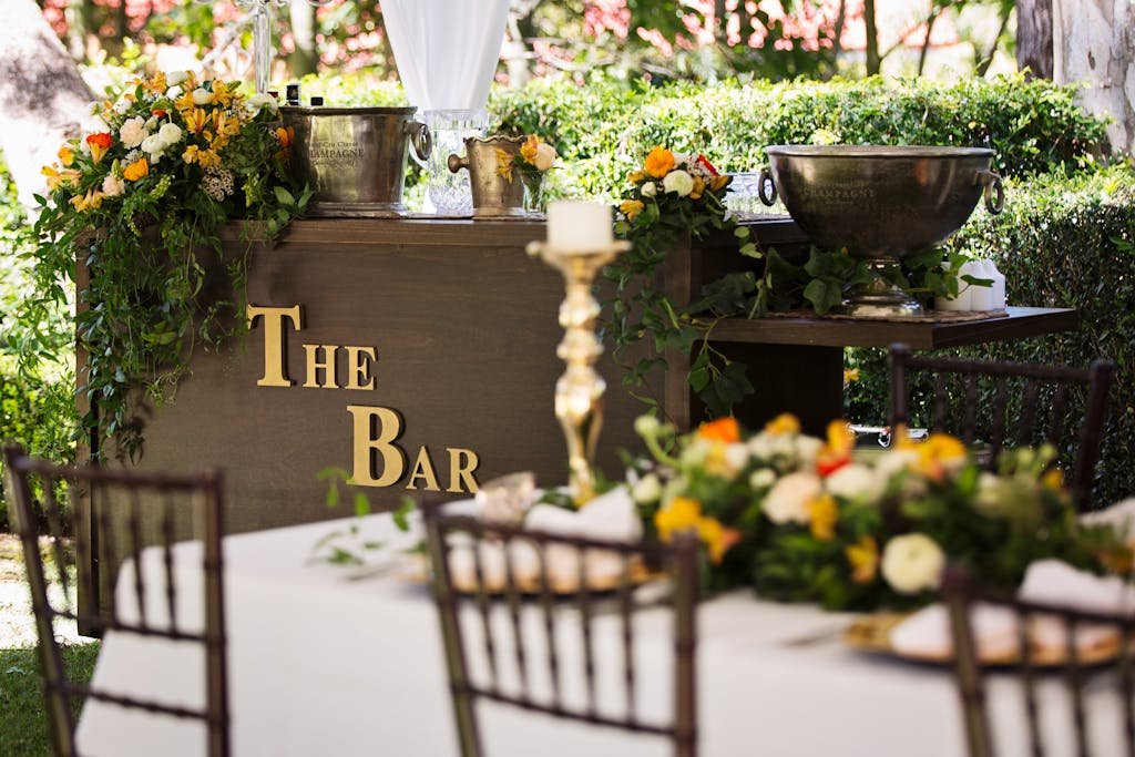 Charming outdoor bar decorated with flowers, perfect for events and receptions.